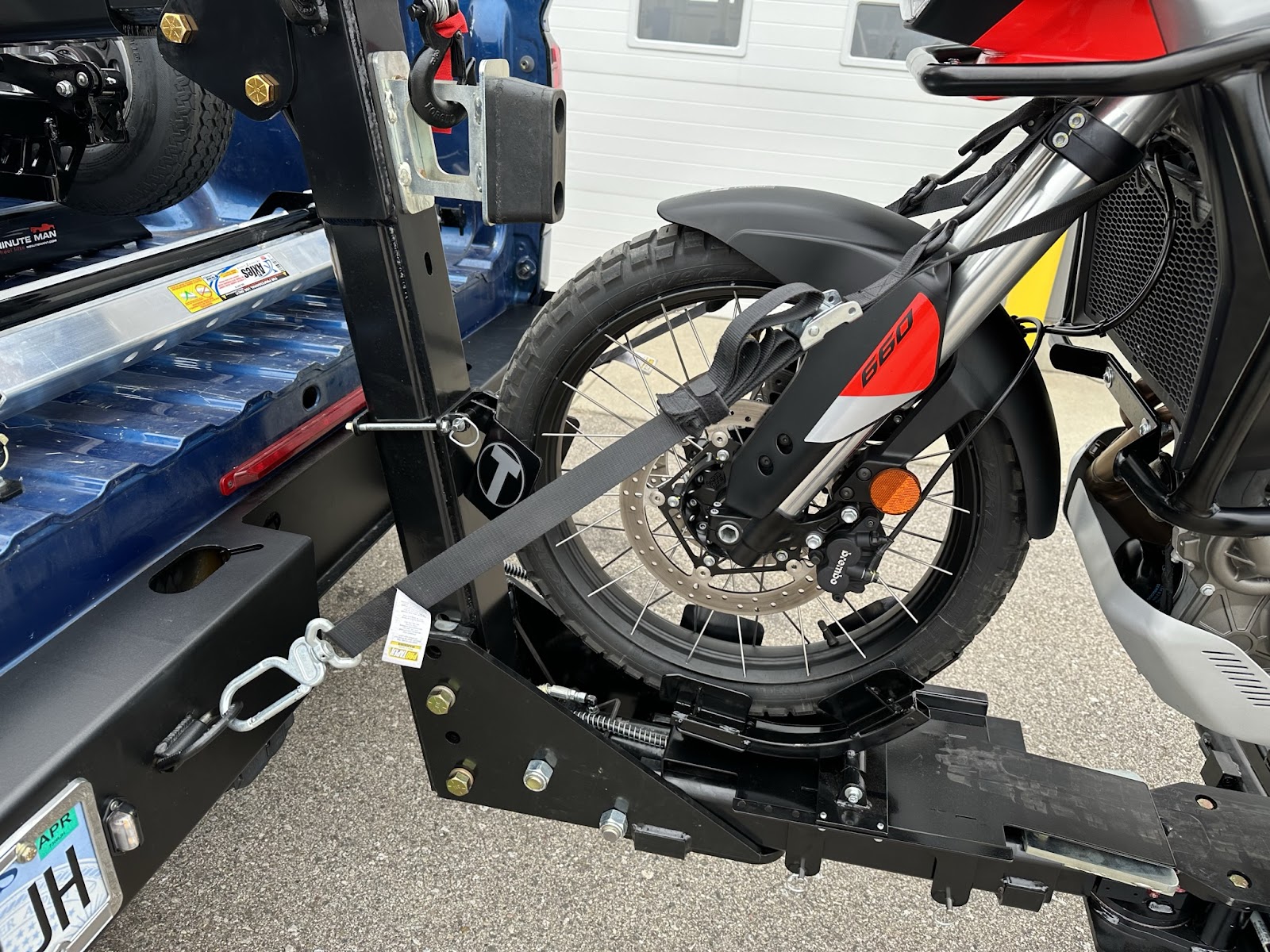 Professional motorcycle towing service loading a bike